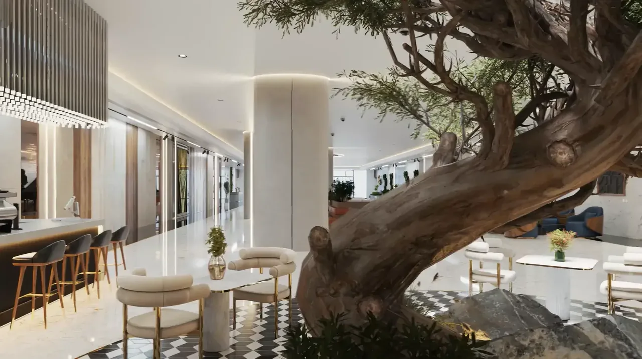 Indoor tree and cafe seating in the Uptown Muscat clubhouse